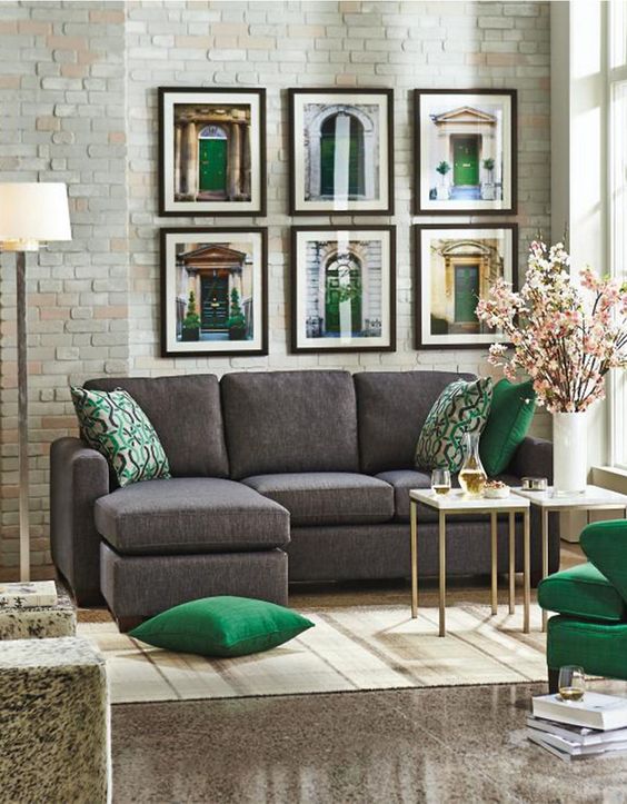 charcoal grey sofa, grey stone floors and emerald and gold details for a chic and sophisticated look