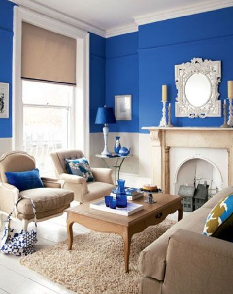 beautiful beige room with splashes of bright blue and a bright blue acent wall