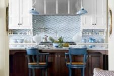 09 blue penny tile and delft pottery lend a watery inluence to this kitchen with white cabinets and stainless steel hood
