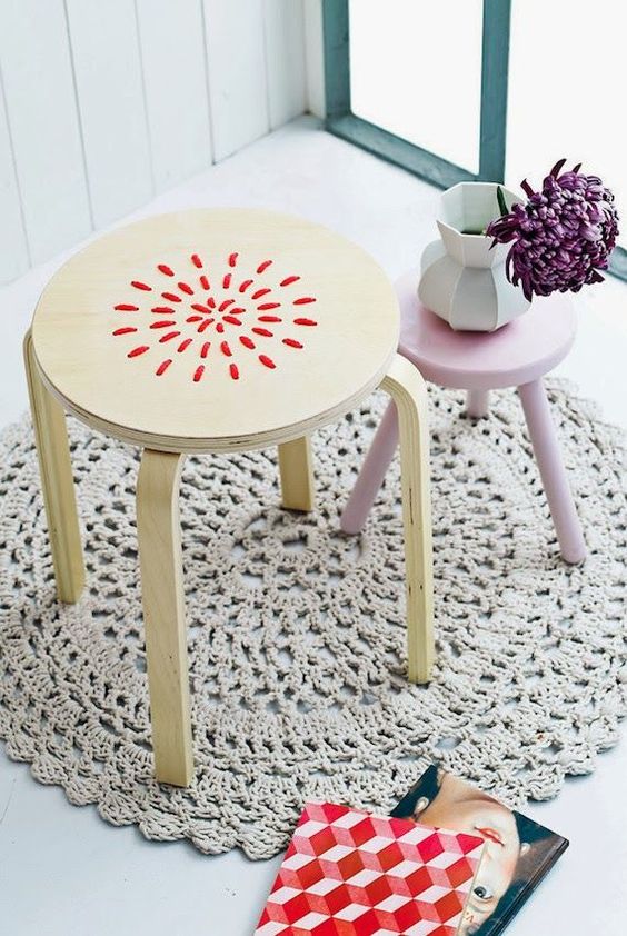 embroidered stool with red yarn