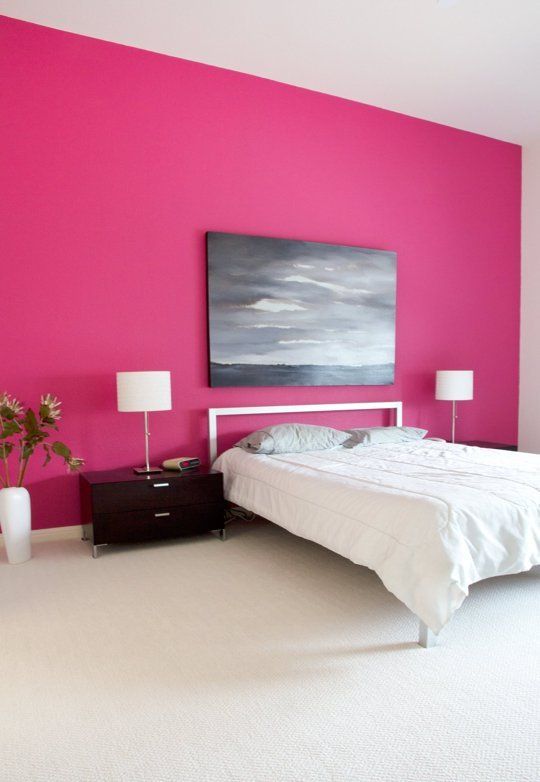 pink wall makes this white bedroom chic, bold and fun