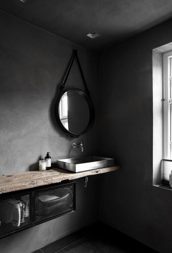 Wabi sabi space with concrete walls and a rough wood counter