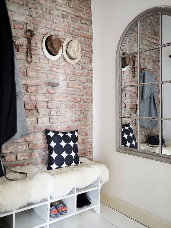 a vintage-inspired entryway decrated with brick plywood panels to give it a style