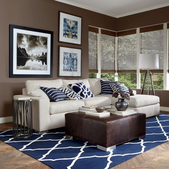 modern brown and white living room with navy pillows and a carpet