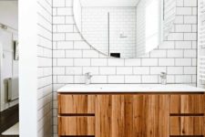 a sink zone clad with white subway tiles that make the stained vanity stand out a lot and give a timeless look to the bathroom