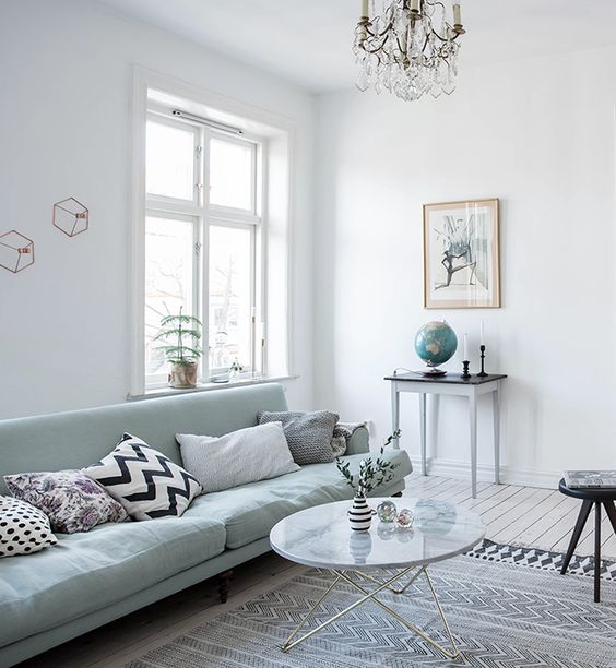 Light filled room with a mint green sofa