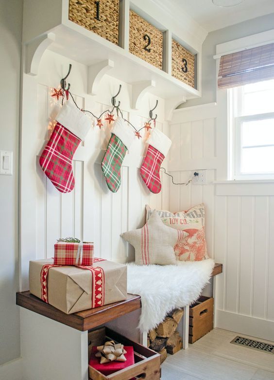 make your guests feel the coming of Christmas using a stocking garland and some gift-looking boxes