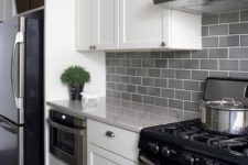 a modern white kitchen with grey subway tiles on the backsplash to add a subtle touch of color and grey countertops