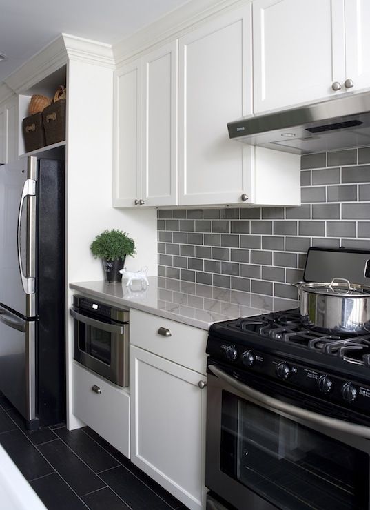 a modern white kitchen with grey subway tiles on the backsplash to add a subtle touch of color and grey countertops