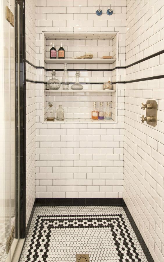 White subway tiles and black and white hex tiles on the floor create a lovely vintage inspired shower space look, add niche shelves