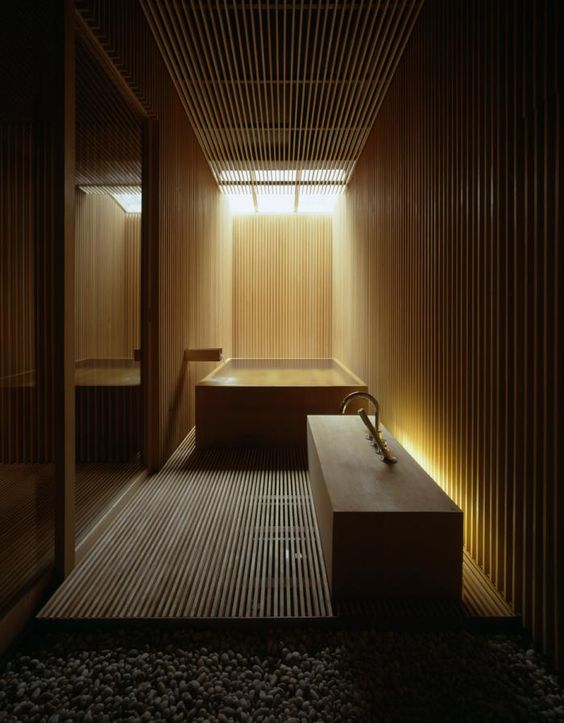 bathroom totally clad with light wood with hidden lights look relaxing and a bit mysterious