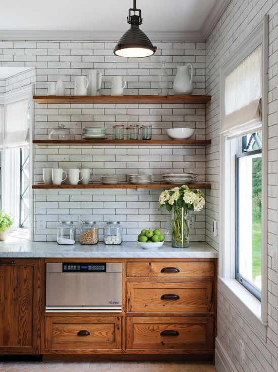 a rustic meets retro kitchen with wooden cabinets and shelves instead of upper cabinets and walls covered with white subway tiles