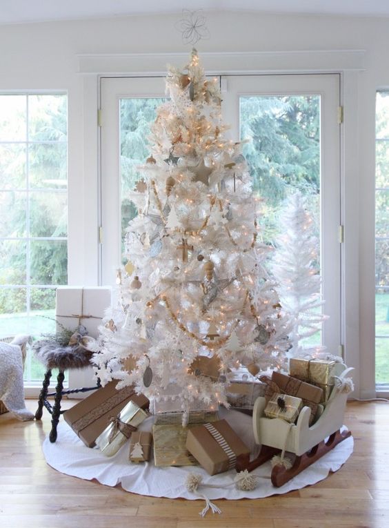vintage white Christmas tree with wooden ornaments and lights