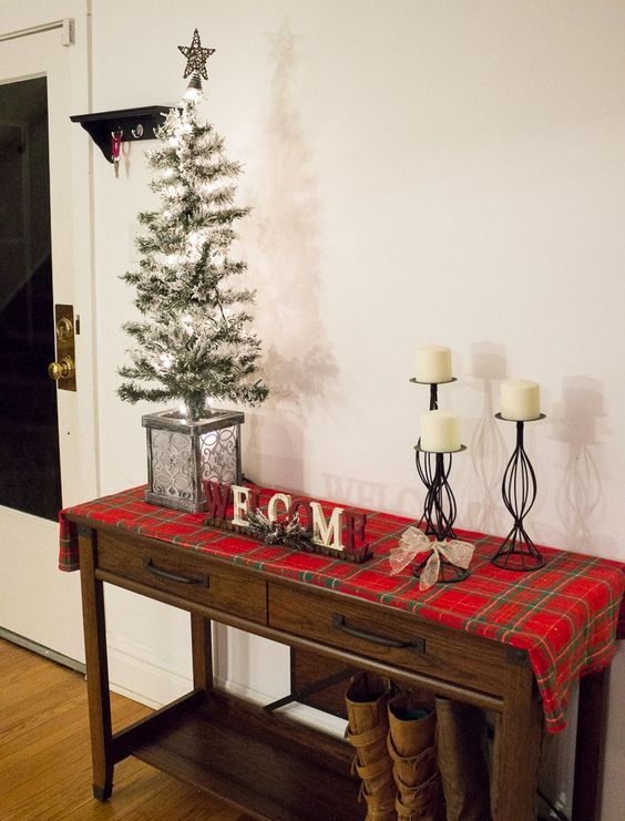 cover your console table with plaid fabric, add candles and a faux Christmas tree