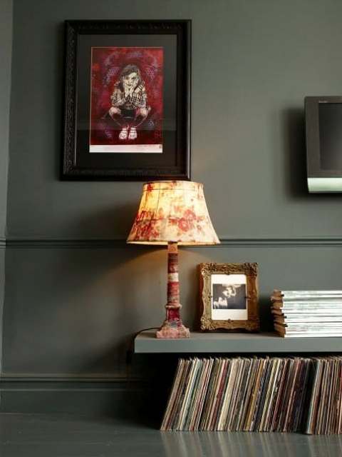 a dark Lack shelf hung just high enough above the dark hardwood floor to allow for record storage underneath