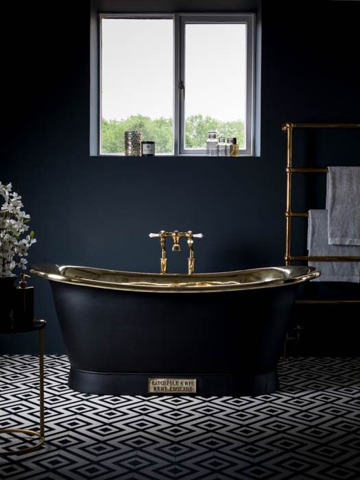 charcoal grey bathroom with brass accents and a retro free-standing bathtub