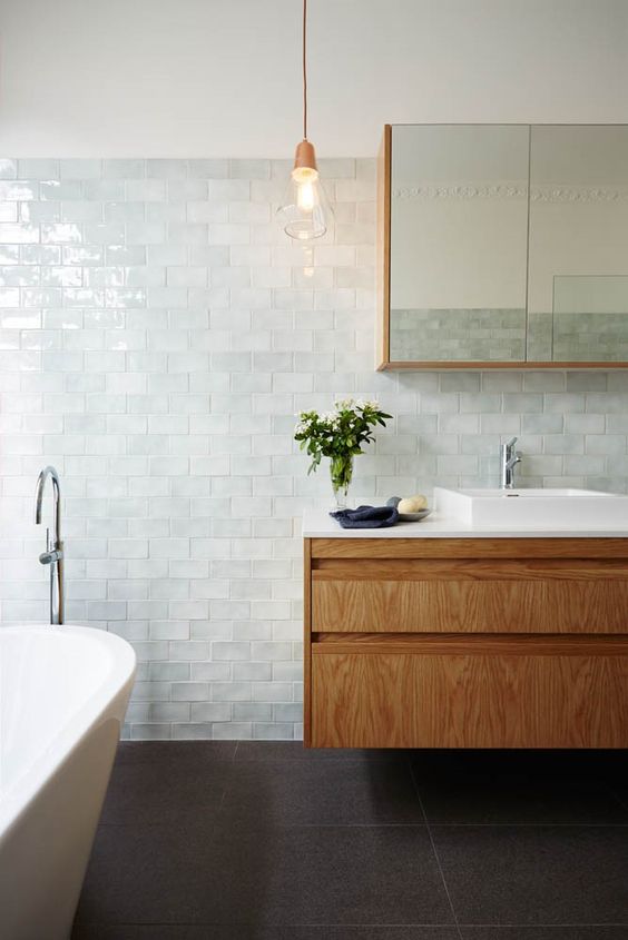 very pale aqua tiles look like a calm sea surface and create a relaxing serene bathroom look, add stained wood for more coziness
