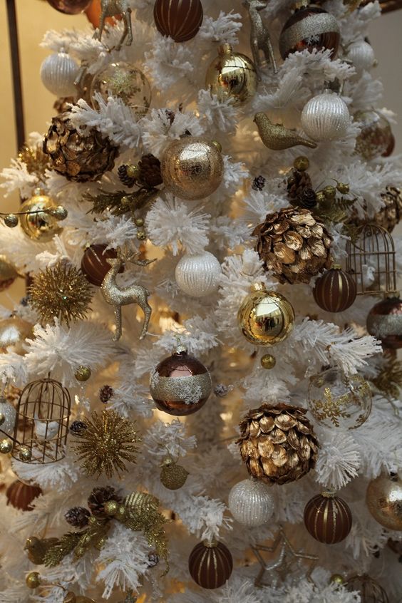 Vintage inspired gold ornaments in a faux white tree