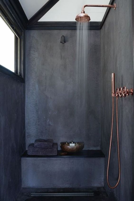 dark grey shower space with copper touches