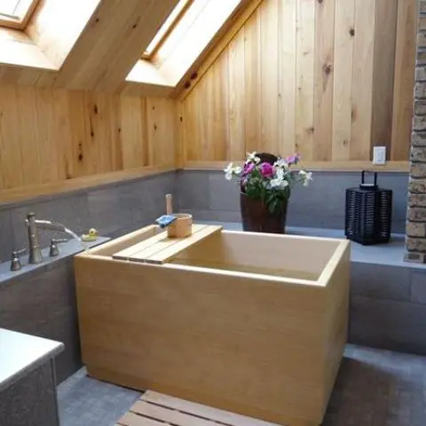light wood on the walls and ceiling echo with a traditional ofuro wooden bathtub
