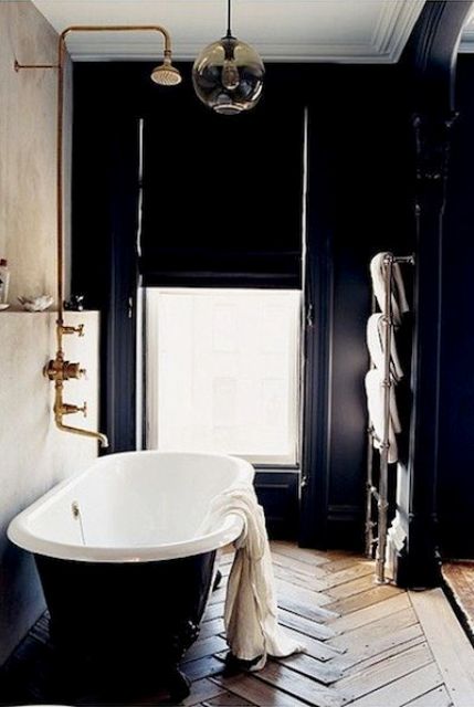 elegant art deco bathroom with a window for a view and a parquet floor