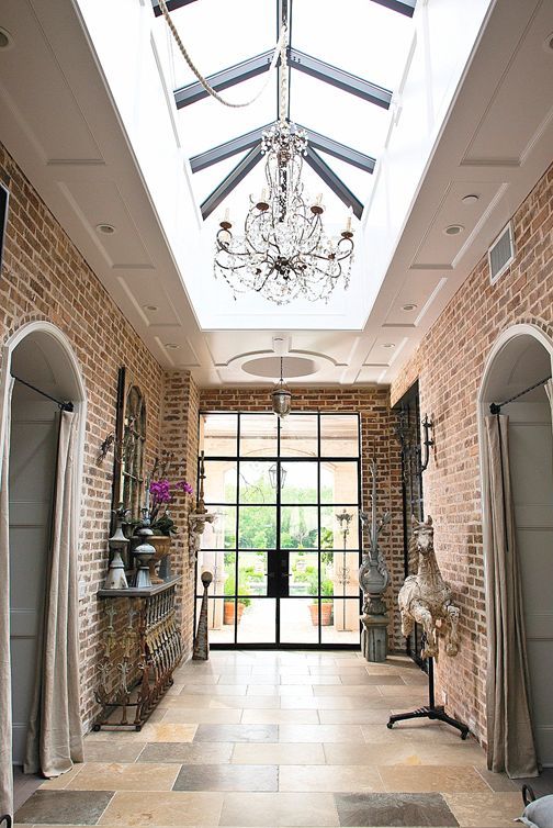 raised roof with the large skylight, arched brick doorways for a refined entryway