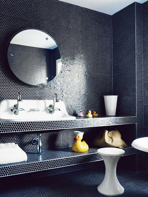 Bathroom with dark blue floor to ceiling penny tile