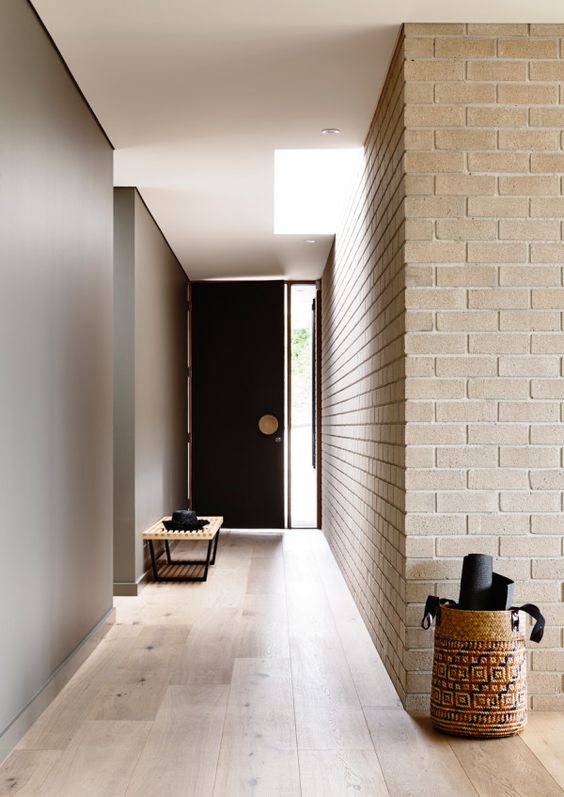 minimalist entryway spruced up with neutral brick wall panels