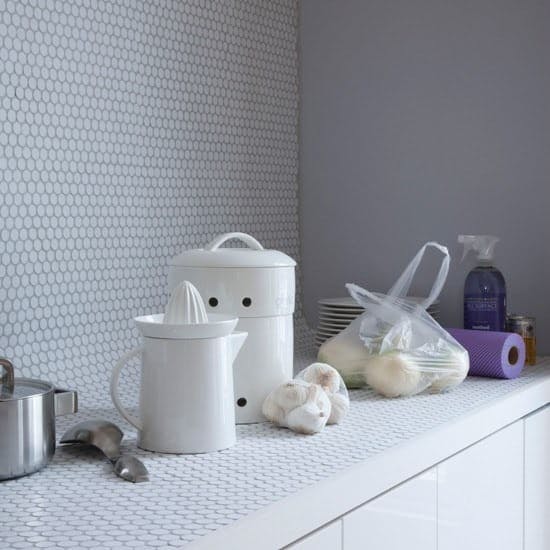a whole countertop covered in penny tiles, a coved transition into a penny tile backsplash