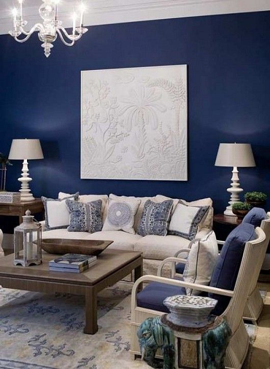 blue accent wall with cream fabric and dark wood for living room