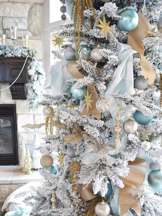 blue and gold decor is ideal for a white Christmas tree