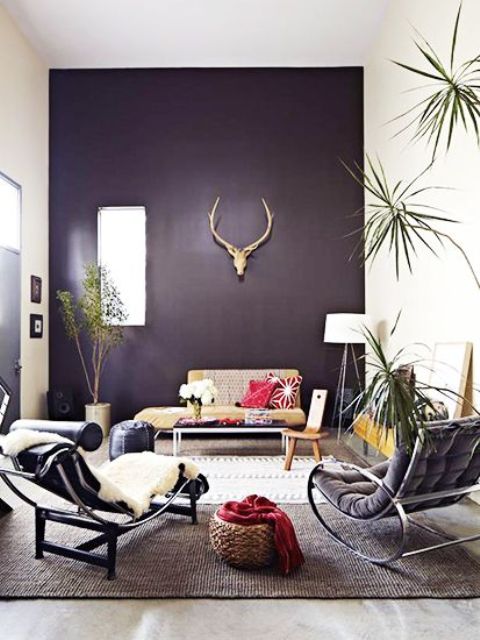 dark purple accent wall accentuates this living room and makes it mysterious and unique