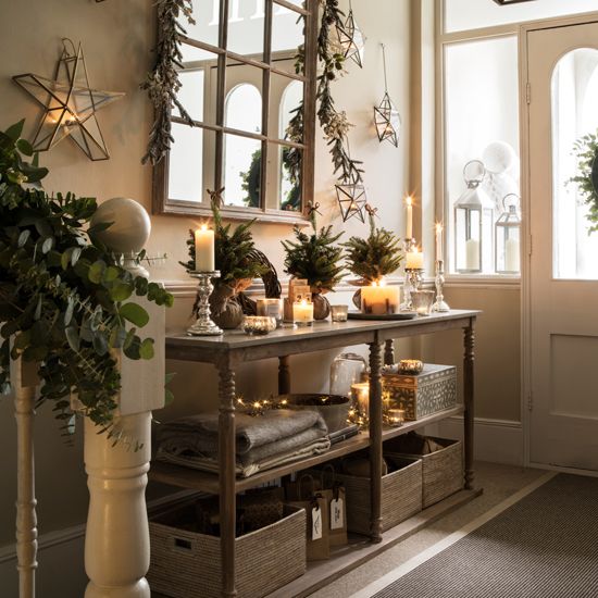 eucalyptus, evergreen branches, 3D stars and lights make the entryway Christmas-like