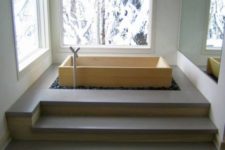 minimalist bathroom design with a wooden soaking bathtub