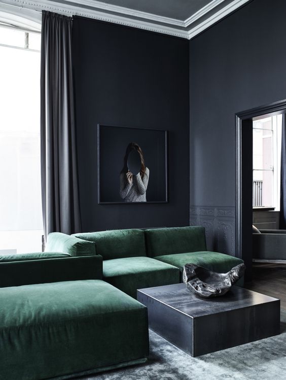 moody modern living room in charcoal grey with green upholstered furniture