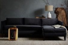21 dark grey walls, a black sofa and raw wood furniture for a natural feel