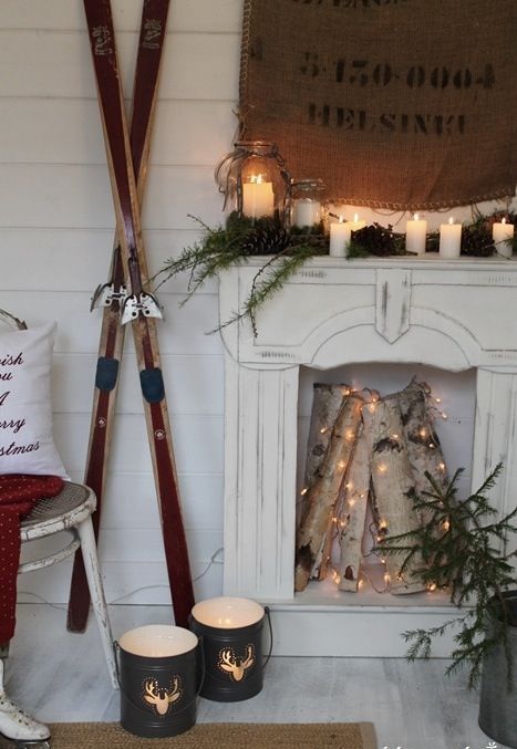 faux fireplace with candle lanterns and firewood decorated with lights