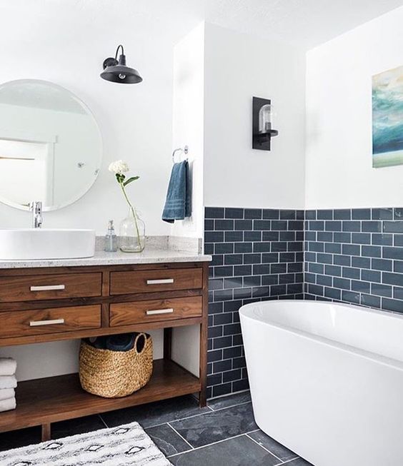 navy subway tiles are an unusual choice, and paired with stained wood and whites they look especially cool