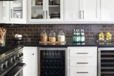 chocolate brown subway tiles look chic with black stone countertops and white cabinetry