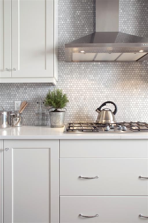 Mother of pearl penny tile backsplash will reflect the light