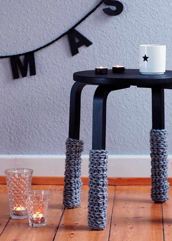 Frosta stool painted black and with crochet leg covers to embrace the winter