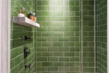a modern shower space fully clad with green subway tiles for a catchy and welcoming look is a good idea as green shades make you feel relaxed