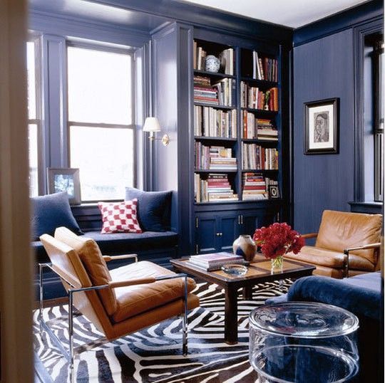 navy space with tan leather chairs, a brown coffee table