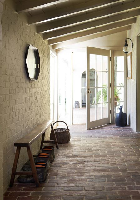 neutral brick walls and red brick floors for a rustic entryway