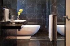 25 luxurious black marble bathroom with a white bathtub