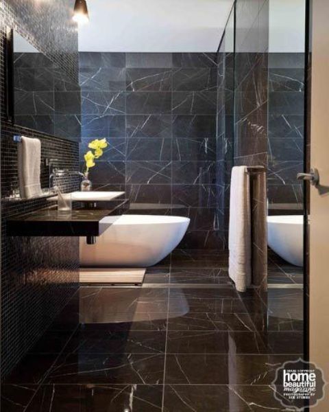 luxurious black marble bathroom with a white bathtub