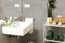 25 white tiles with black grout all over the bathroom