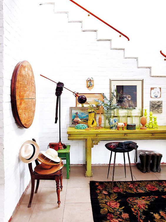eclectic mudroom with white brick walls and bold furniture