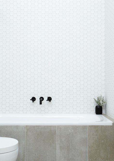 white large penny tiles over the bathtub
