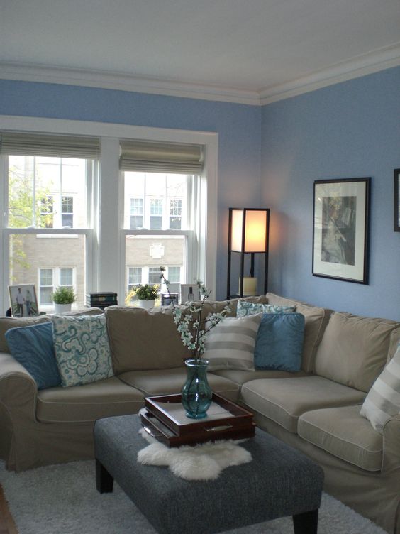 light blue walls and textiles and a tan couch look refined